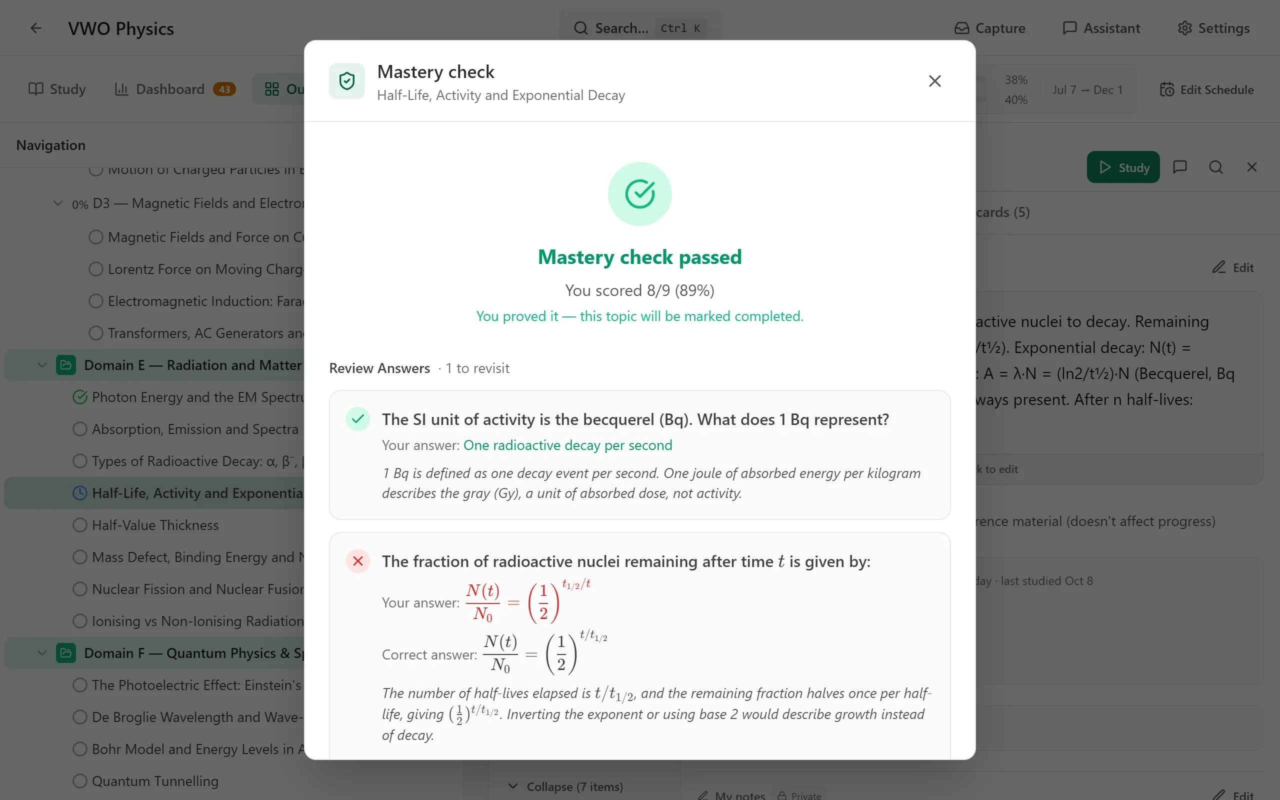 a Mastery check dialog for the topic Half-Life, Activity and Exponential Decay: a green tick, Mastery check passed, You scored 8/9 (89%), and the answers reviewed below it, one about the becquerel marked right and one with the decay formula's exponent inverted marked wrong next to the correct formula