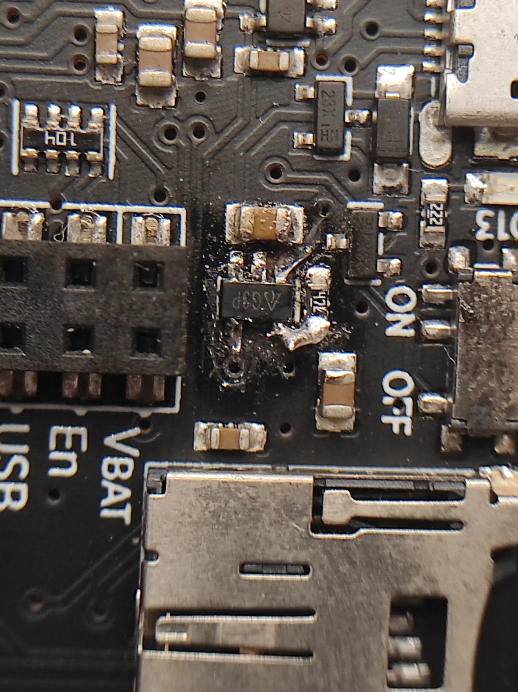 close-up of the same spot with a new five-pin chip marked G3P soldered in and a thin wire beside it